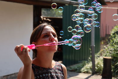 Full length of girl holding bubbles