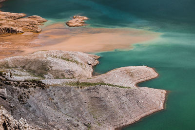 High angle view of rocks in water against sky