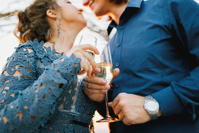 Midsection of couple holding ice cream