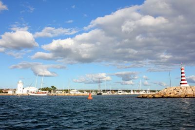 Scenic view of sea by buildings against sky