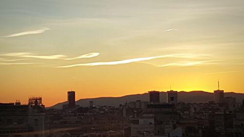 Cityscape against sky during sunset