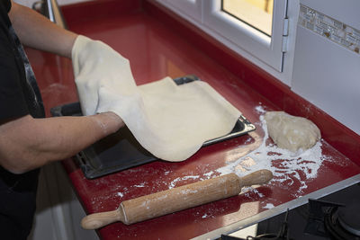 Midsection of person preparing food in kitchen