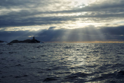 Scenic view of sea against cloudy sky