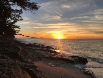 Scenic view of sea against orange sky