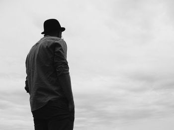 Rear view of man standing against sky