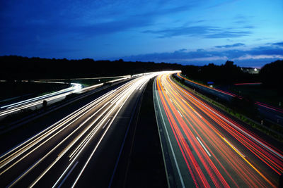 High angle view of light trails on highway at night