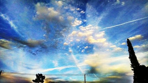 Low angle view of vapor trails against sky