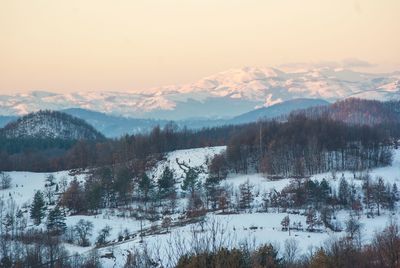 Scenic view of snowcapped mountains against sky during winter