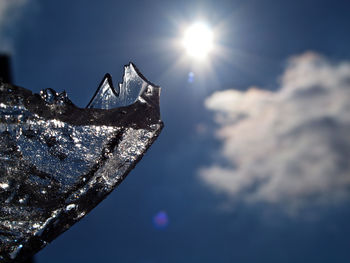 Low angle view of ice against bright sun