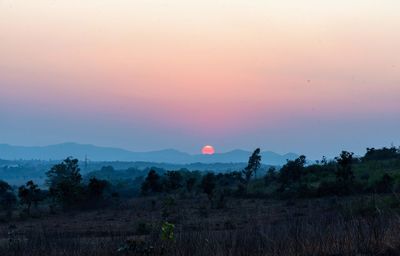 Scenic view of field against sky during sunset