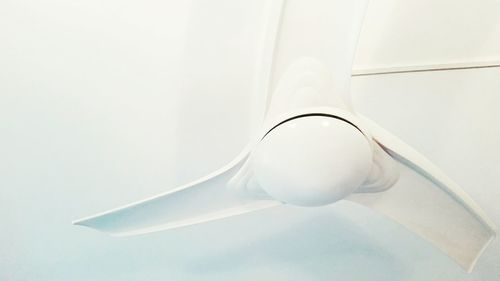 Close-up of electric fan against white background