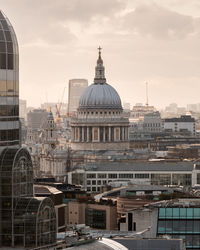 Buildings in city against sky during sunset