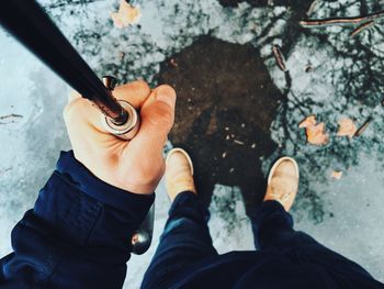 Low section of people standing on tiled floor