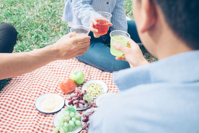 High angle view of people drinking glass on table