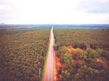 Aerial view of road by sea against sky