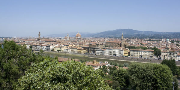 View of buildings in city against clear sky