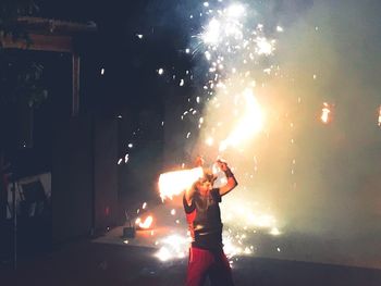 Woman with fire crackers at night