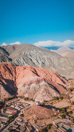 Aerial view of desert against blue sky