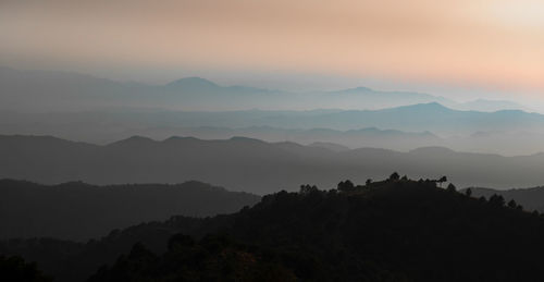 Scenic view of silhouette mountains against sky during sunset