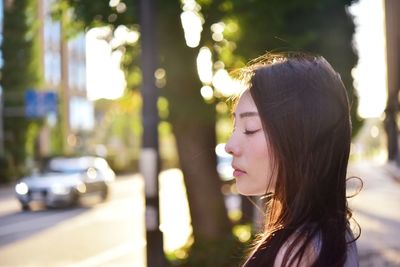Portrait of beautiful young woman in city