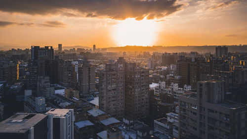 High angle view of buildings against sky during sunset