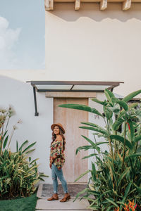 Woman standing by building