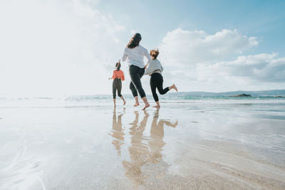 Rear view of woman walking on beach