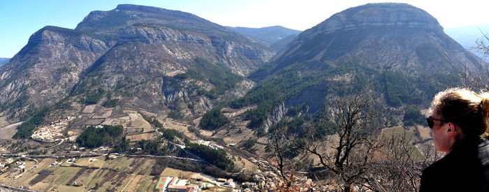 Side view of woman against mountains