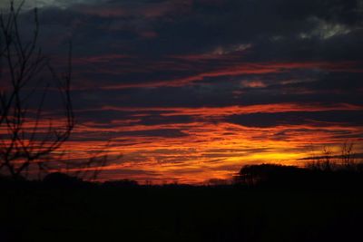 Silhouette landscape against sky at sunset