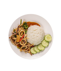 High angle view of food in plate against white background