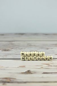 Close-up of text on table against sea