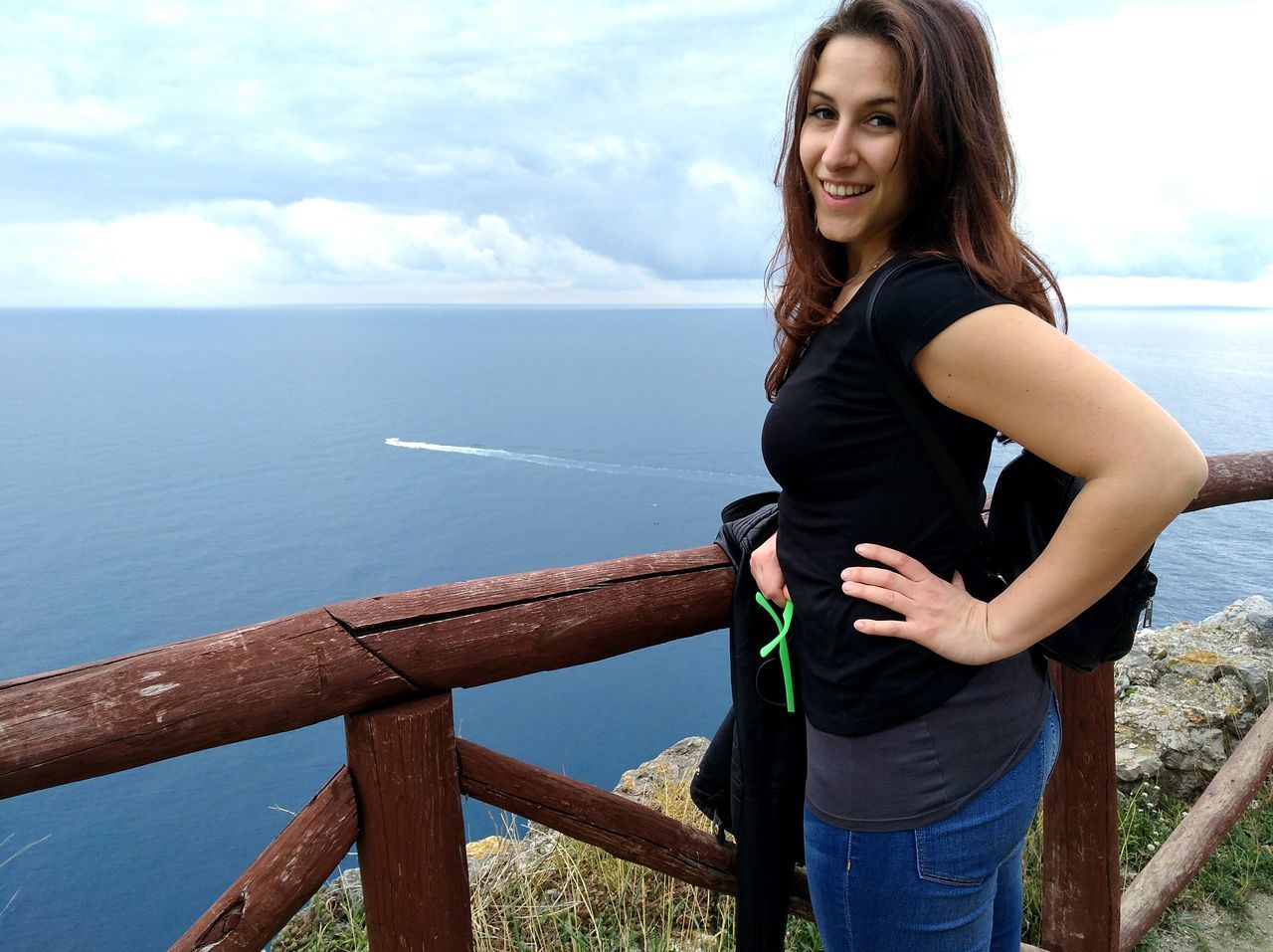 portrait, sea, looking at camera, one woman only, one person, only women, three quarter length, adults only, beautiful woman, smiling, young adult, one young woman only, day, horizon over water, adult, young women, people, beach, outdoors, beauty in nature, water, nature