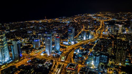 High angle view of city lit up at night