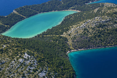 High angle view of bay against clear blue sky