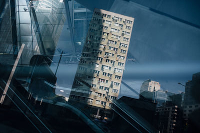 Digital composite image of modern buildings against sky