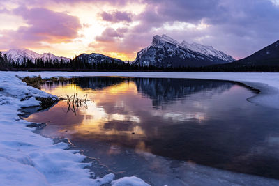 Reflection of the mountains and beautiful sunrise over the vermillion lakes in banff national park.