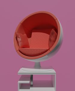 Close-up of armchair against pink background