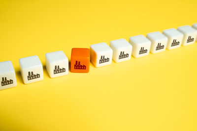 Close-up of toy blocks on yellow background
