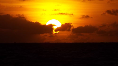 Scenic view of sea against orange sky