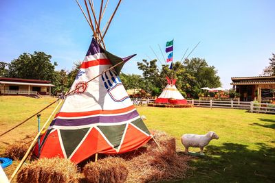 Traditional windmill on field against sky