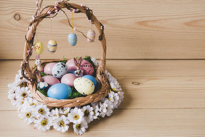 High angle view of easter eggs in basket on table