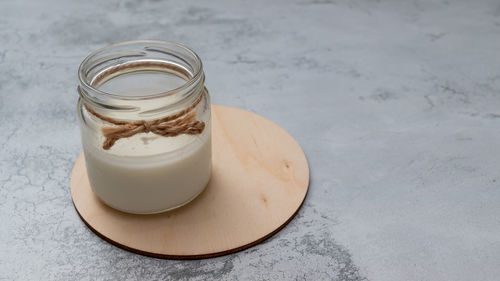 Glass jar with milk in daylight. world vegetarian day. zero lactose, reusable package. non-allergic 