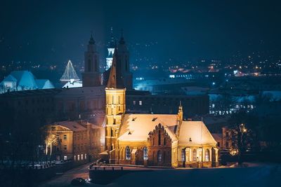 Illuminated cityscape against sky at night