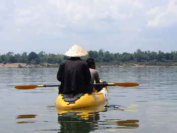 Rear view of two men in kayak