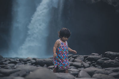 Girl walking among rocks