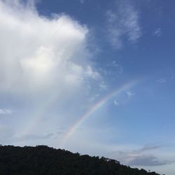 Low angle view of rainbow against sky