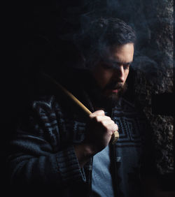 Portrait of young man smoking cigarette