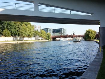 Bridge over river with city in background