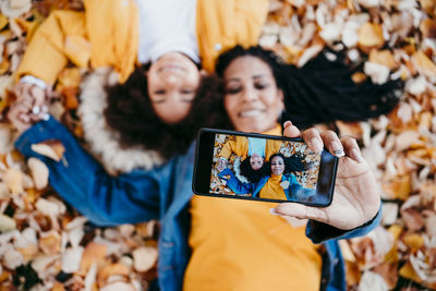 Woman photographing with mobile phone