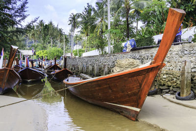 Boats moored on beach against sky